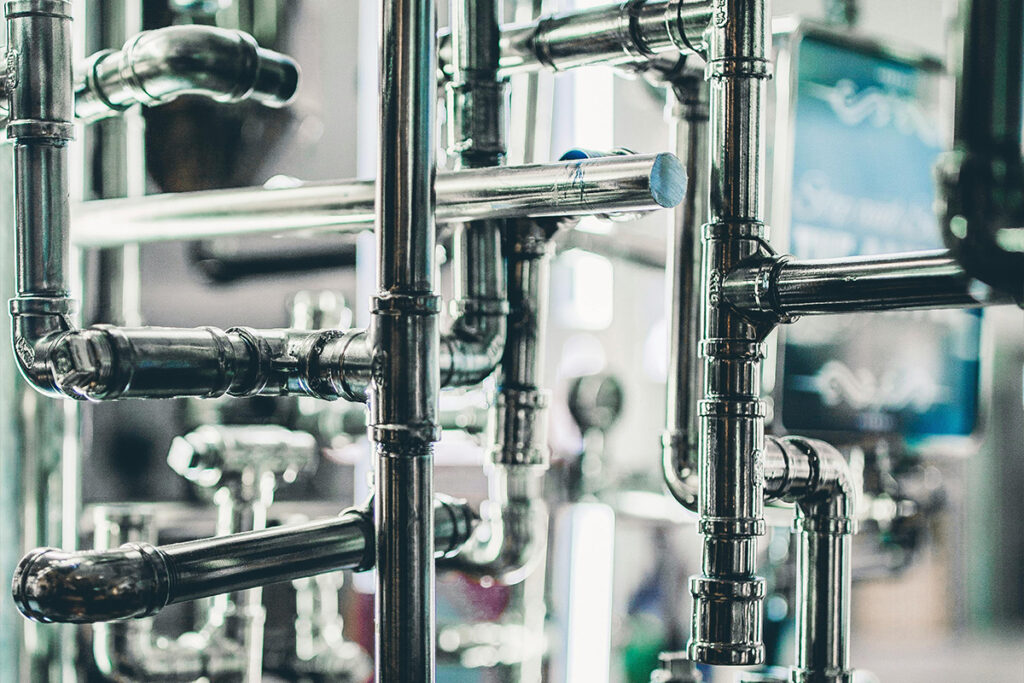 A detailed network of plumbing pipes, illustrating the systems involved in how to become a plumber.